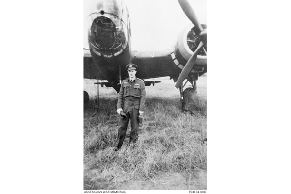 A pilot standing with a Handley Page Hampden bomber aircraft.