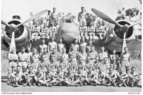 Group portrait of members of No 31 Squadron assembled on and in front of one of the unit's Bristol Beaufighter aircraft