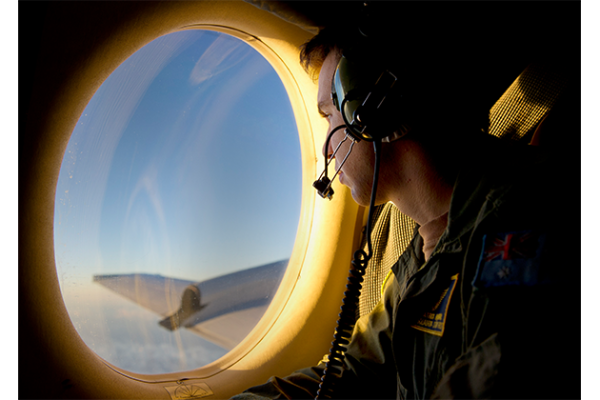 An AP-3C Orion Crew member visually searching for the missing MH370